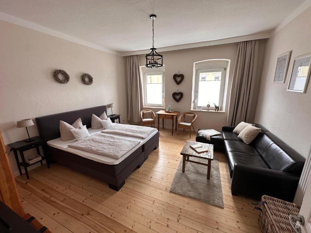 a living room with a bed and a couch at Haus 1a in Lauterecken