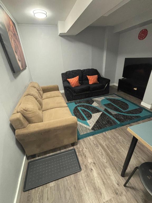 a living room with a couch and a table at Cute Highlandpark (Lower A Unit) in Calgary