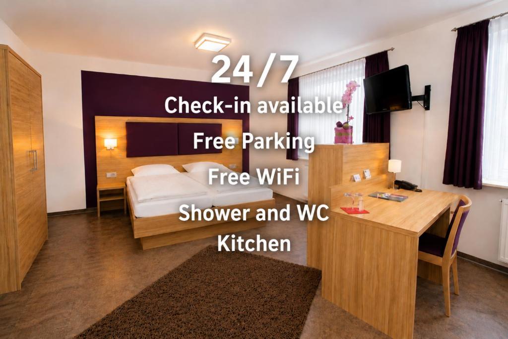 a hotel room with a bed and a desk and a room at Hotel Pale Wolfsburg 24H Self Check-in in Wolfsburg