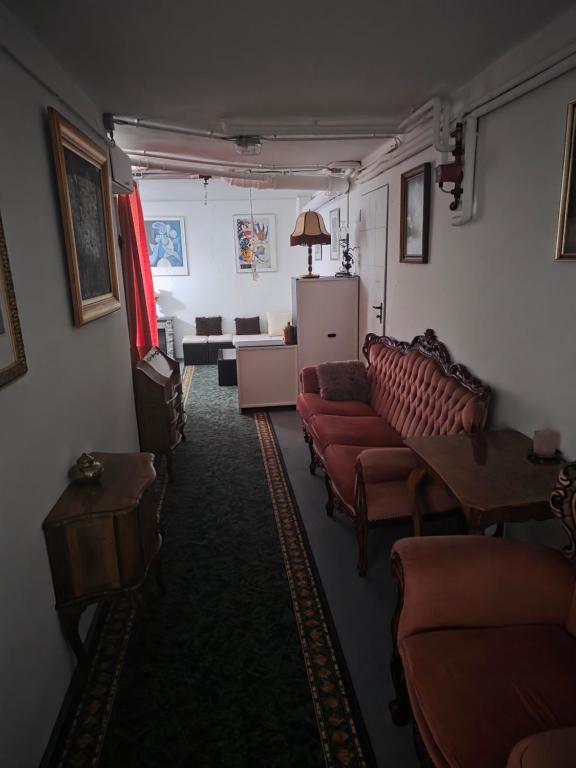 a living room with couches and a table and a living room at Уютная пещера in Klosterneuburg