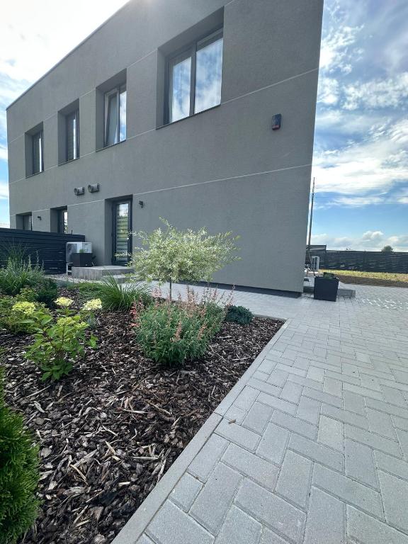 a house with a brick walkway in front of it at Raudondvaris holiday home in Raudondvaris