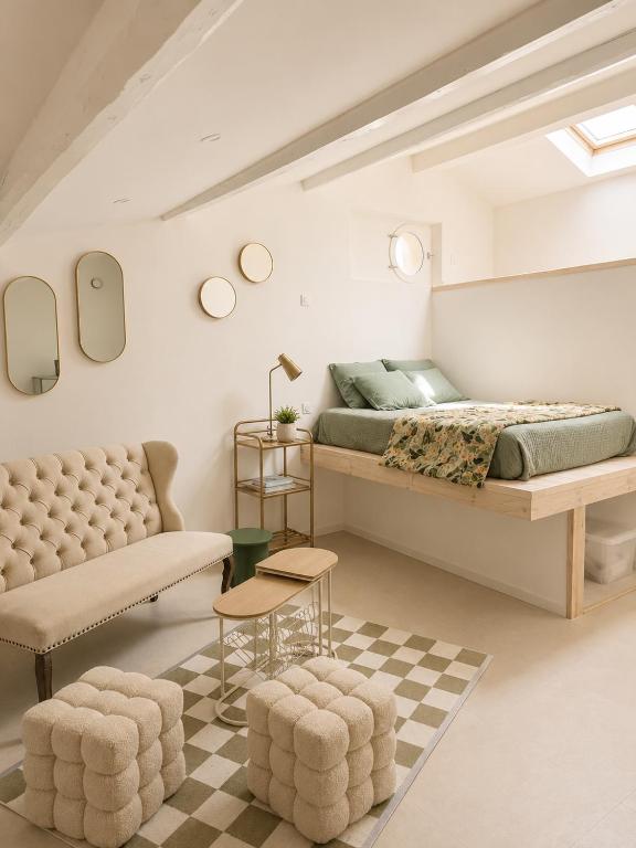 a bedroom with a king sized bed and a couch at Studios Riviera in Bandol