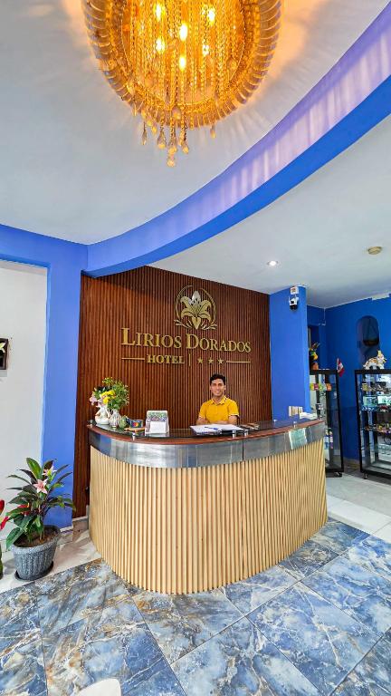 a man sitting at a bar in a restaurant at Hotel Lirios Dorados in Iquitos