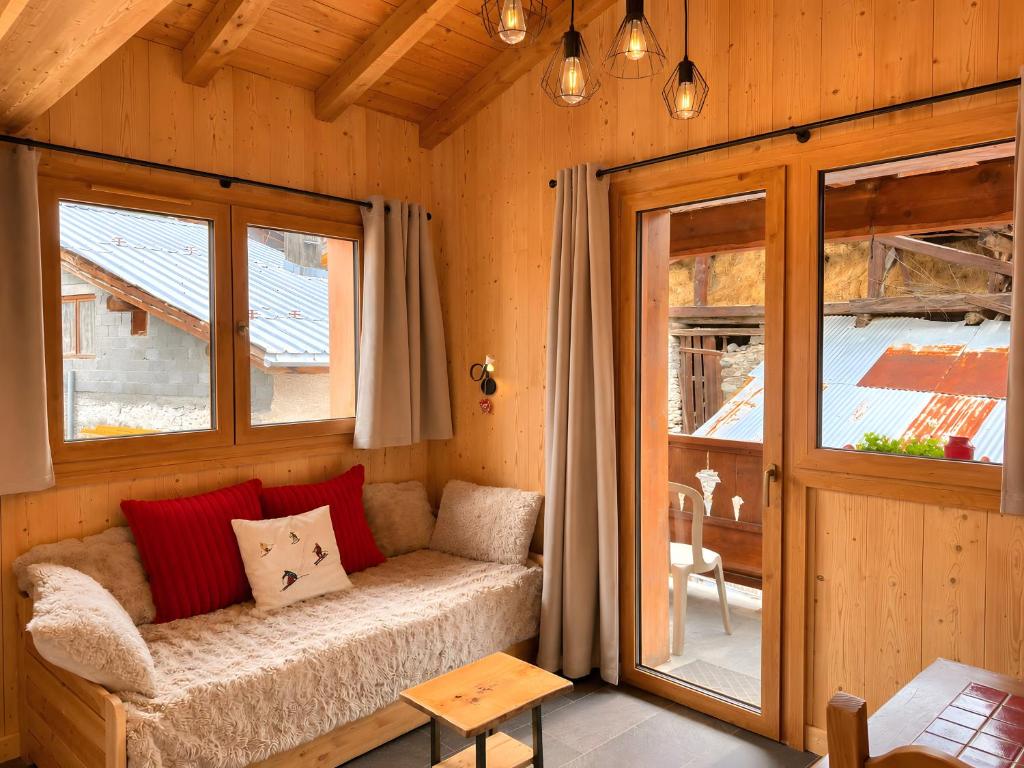 a living room with a couch in a wooden cabin at L'edelweiss in La Plagne Tarentaise