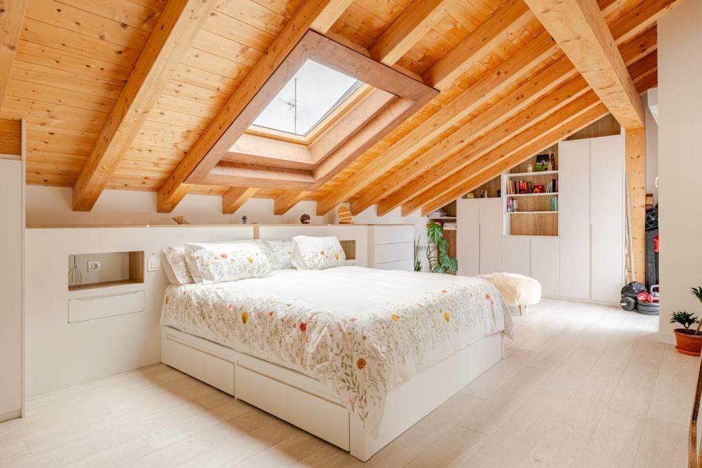 a bedroom with a large bed in a wooden ceiling at Duplex in Durango's old town in Durango
