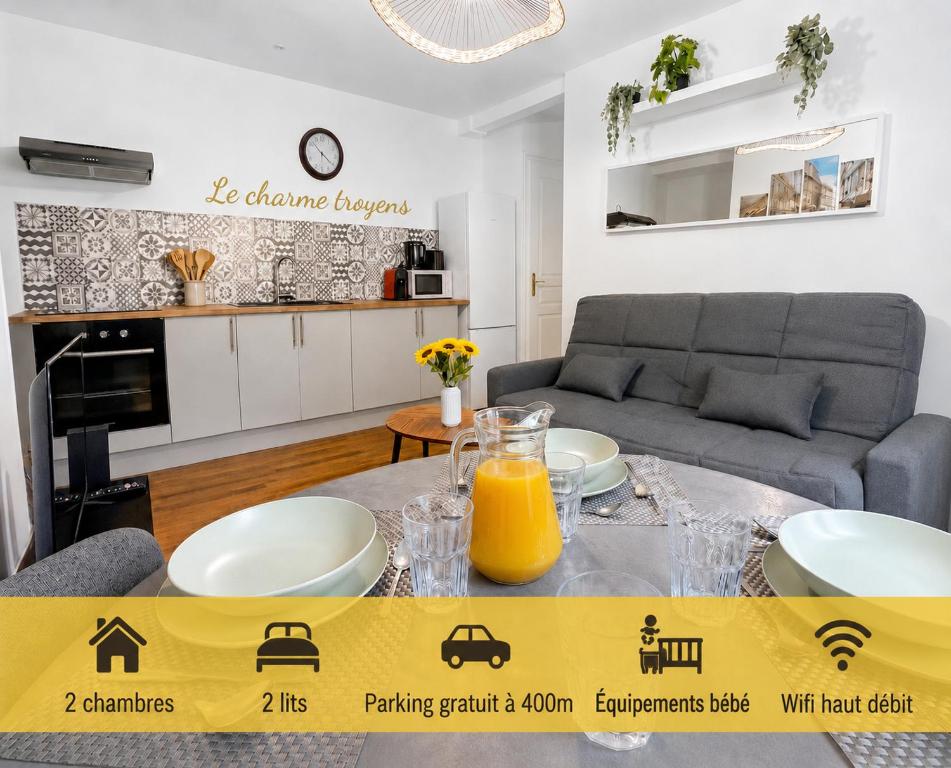 a living room with a table with orange juice on it at Calme et confort au cœur du vieux Troyes in Troyes