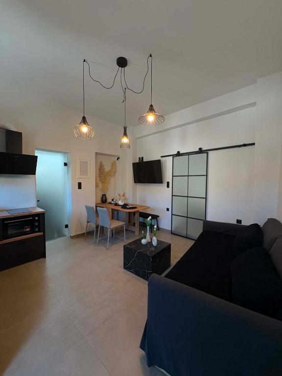 a living room with a couch and a table at Alegria Suite in Ermoupoli
