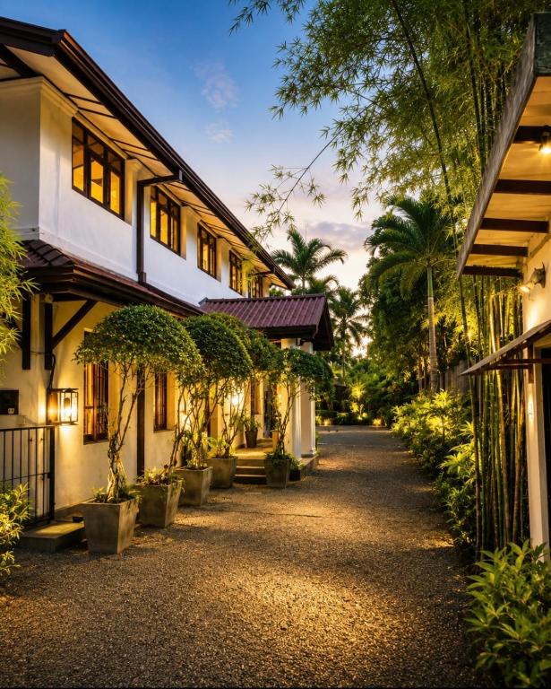 a street in front of a building with trees at The Manor 1926 in Colombo