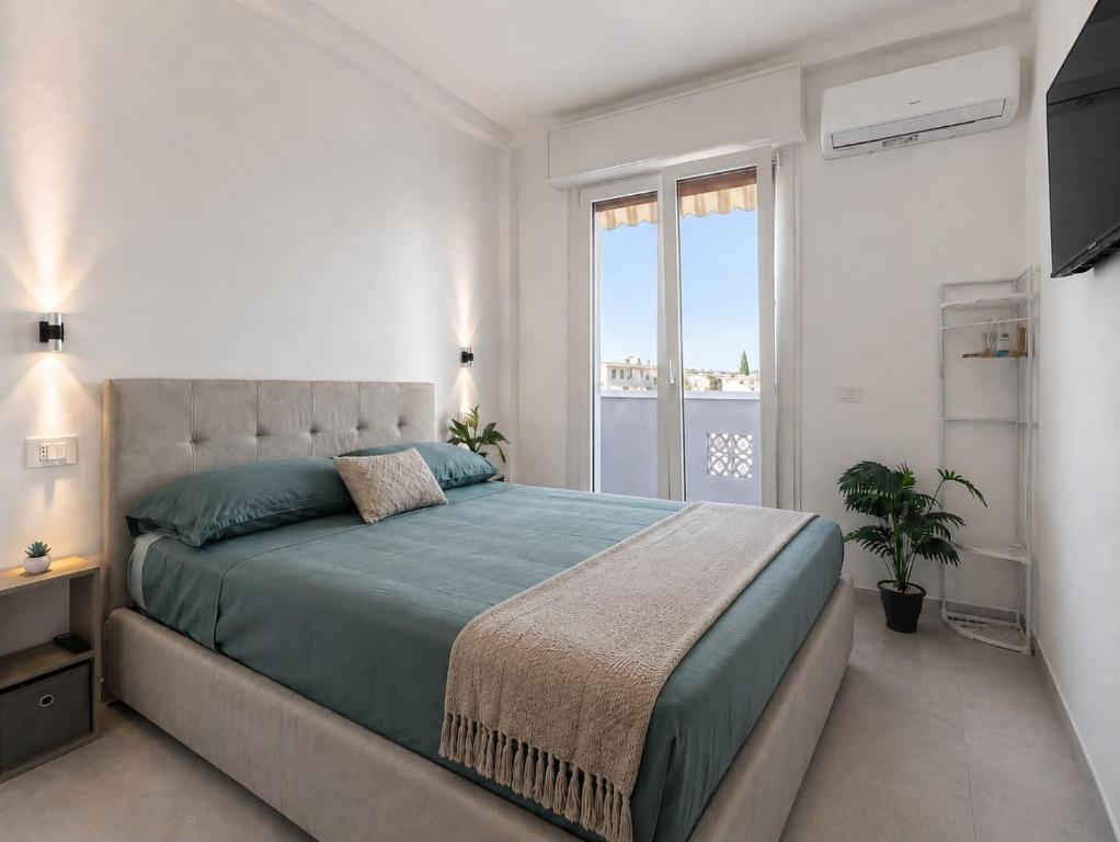 a bedroom with a large bed and a large window at Mellini Living in Misano Adriatico