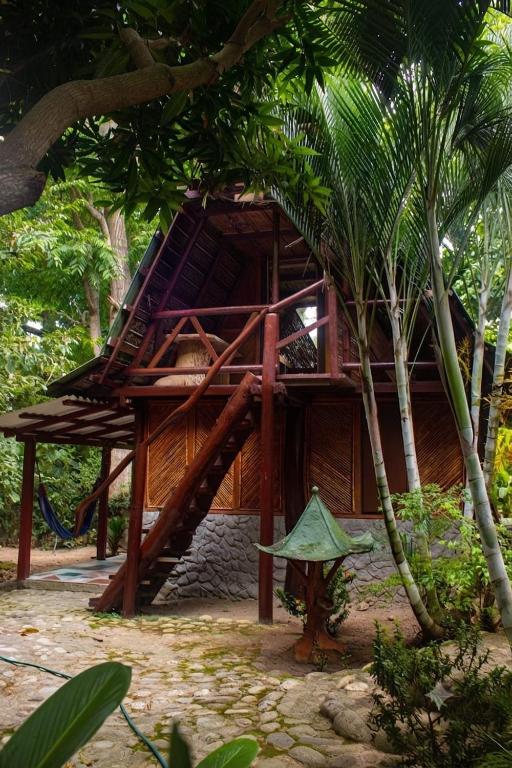 a tree house with a staircase leading up to it at A-típico in Santa Marta