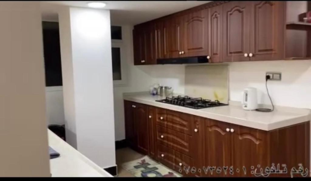 a kitchen with wooden cabinets and a stove top oven at Sulav amedi in Sūlav