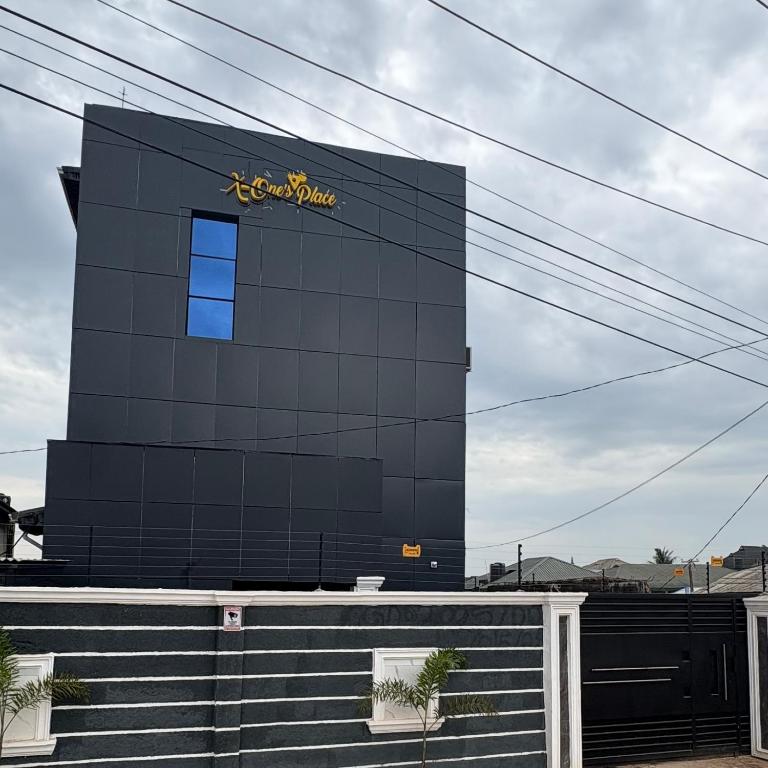a black building with a yellow sign on it at X-ones place command in Meran