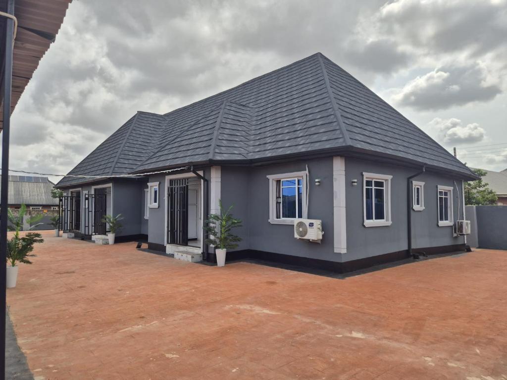 a small house with a black roof at D-vine Apartments & Hotels in Benin City