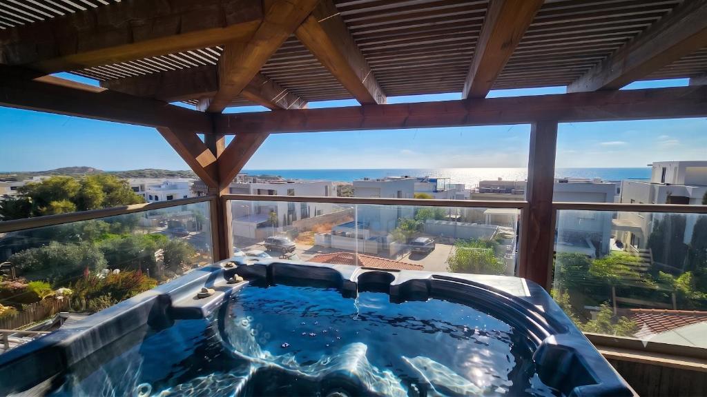 a hot tub in a room with a view at Gador Sea View in H̱adera
