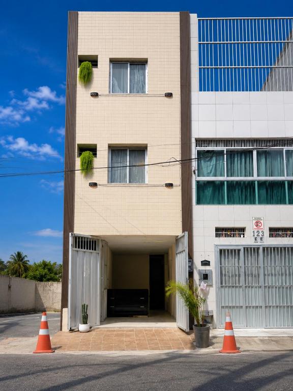 a building with orange traffic cones in front of it at Brisa Mar in Fortaleza
