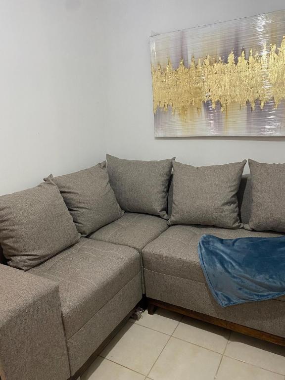 a couch in a living room with a painting on the wall at Ruah Home in Guadalupe