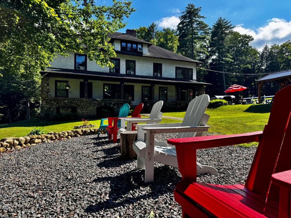 a row of lawn chairs in front of a house at Rock Castle Resort in Lake George
