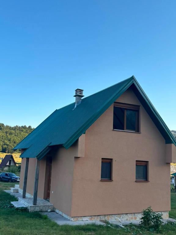 a house with a green roof at Gabriels7 in Korita
