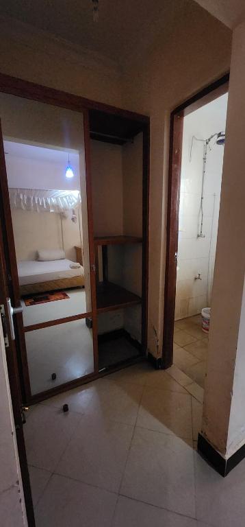 an empty room with an open door to a bedroom at Tarakea Lodge in Mbuguni