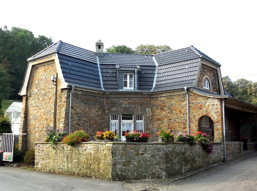 a brick house with a roof on top of it at Natursteinvilla am Goldberg in Hagen