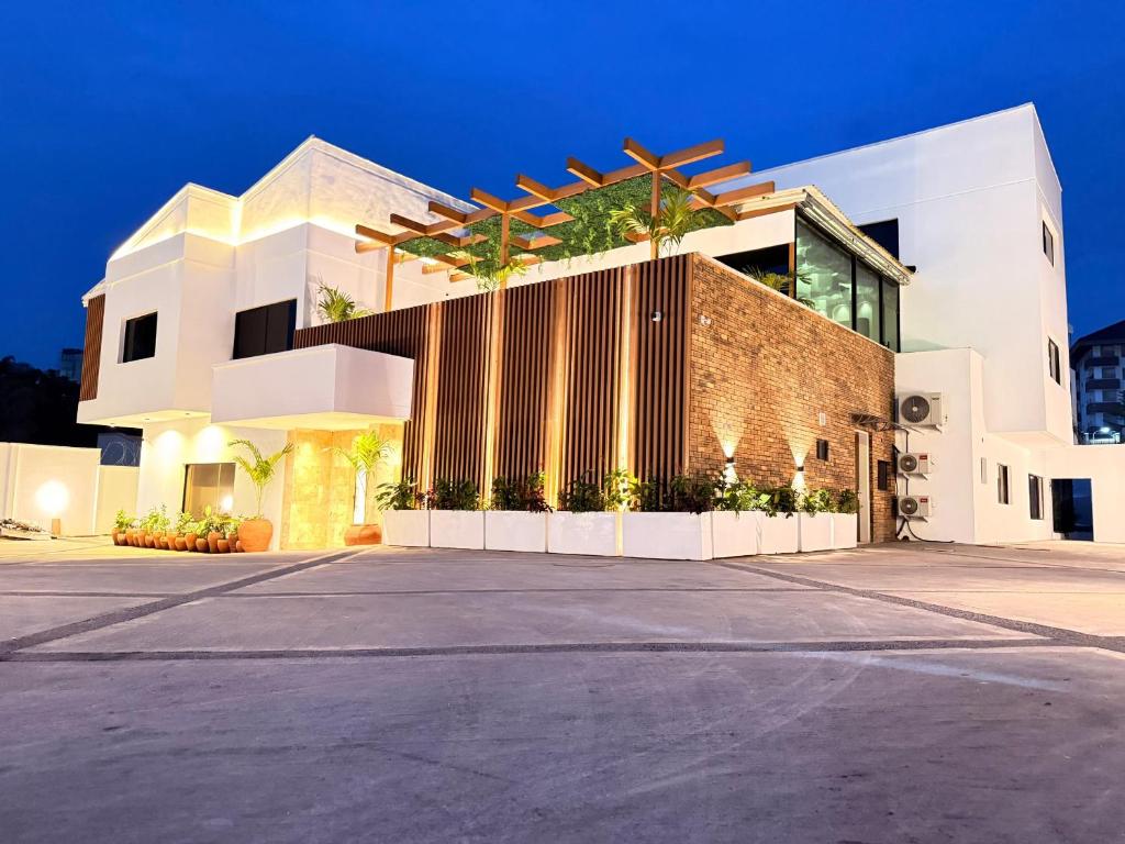 a large white building with a fence in front of it at Amazonia Luxury in Abuja