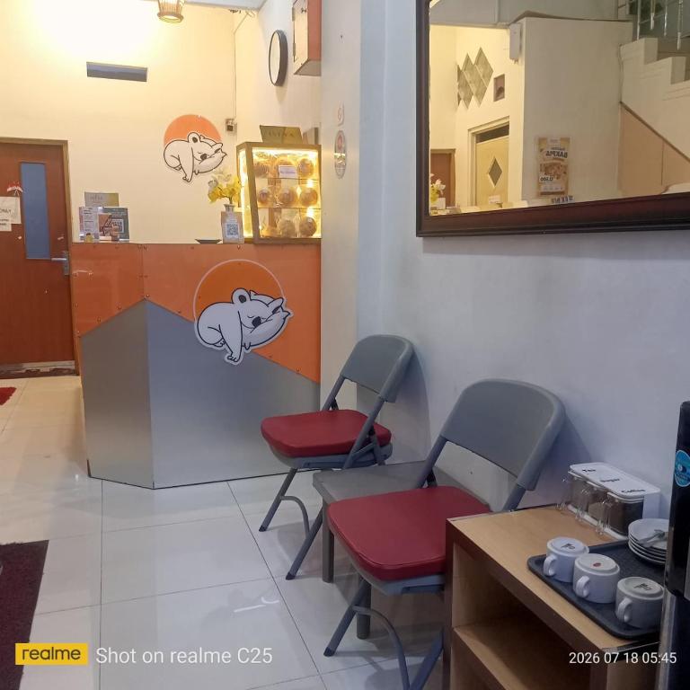a waiting room with two chairs and a counter at The Cabin Hotel Ngupasan in Yogyakarta