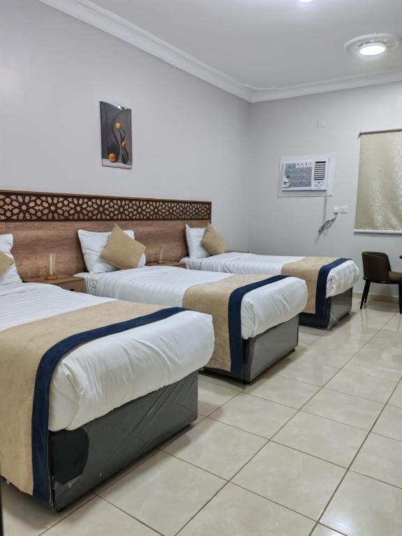 a group of three beds in a room at شقق مفروشة مكين 1 in Medina