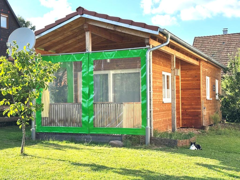 a small house with a green trim at Tiny-Ferienhäusle Casa Wendy in Loßburg