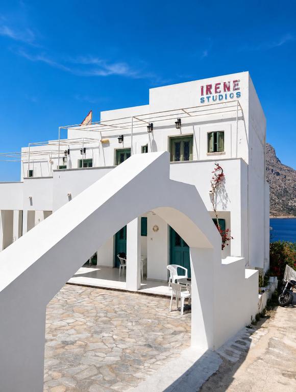 a white building with an arch in front of it at Sevi - Irene Studios in Masouri