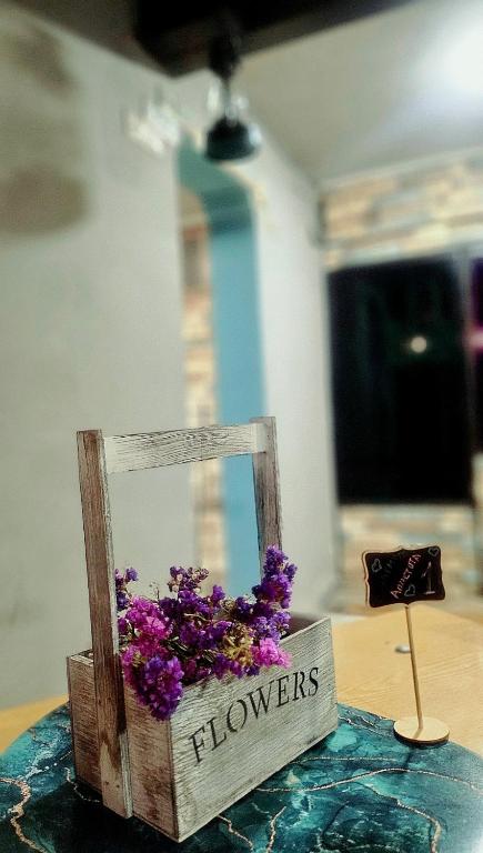 a wooden box with purple flowers on a table at ASINE Dilijan in Dilijan