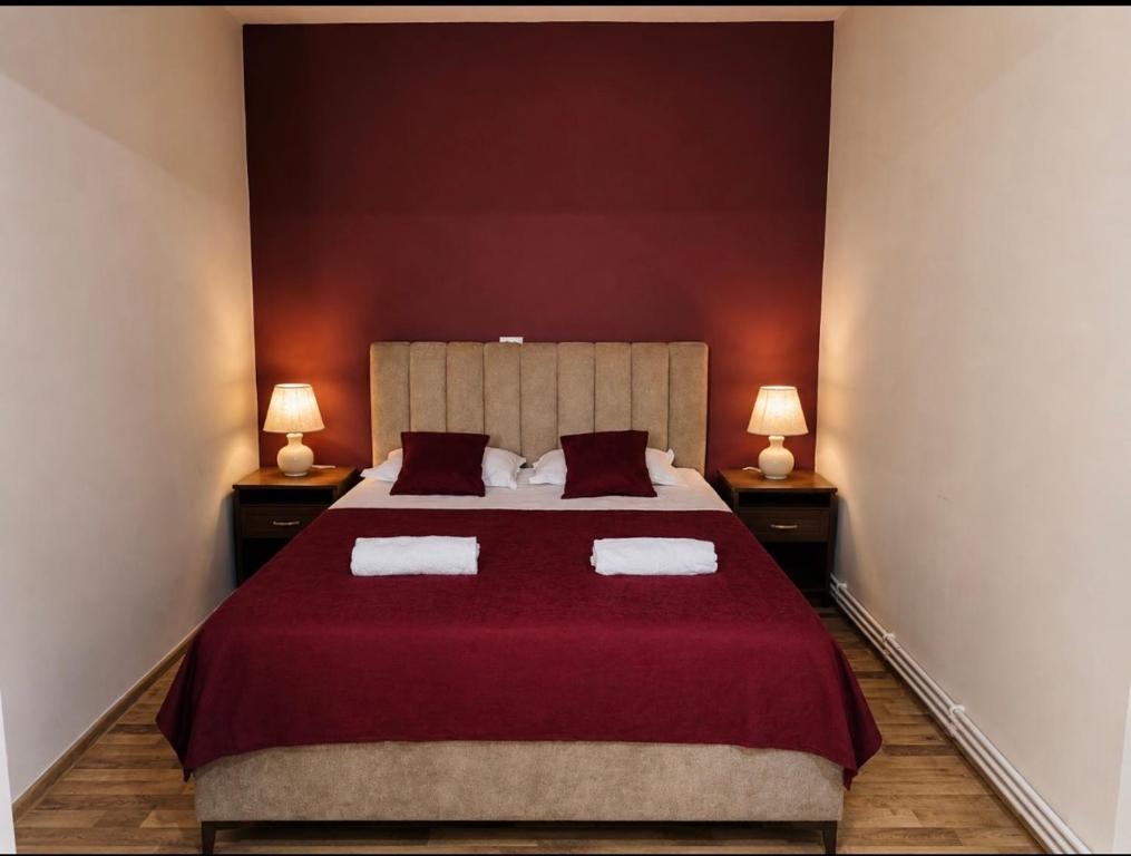 a bedroom with a large bed with two lamps at Old Rabati in Akhaltsikhe