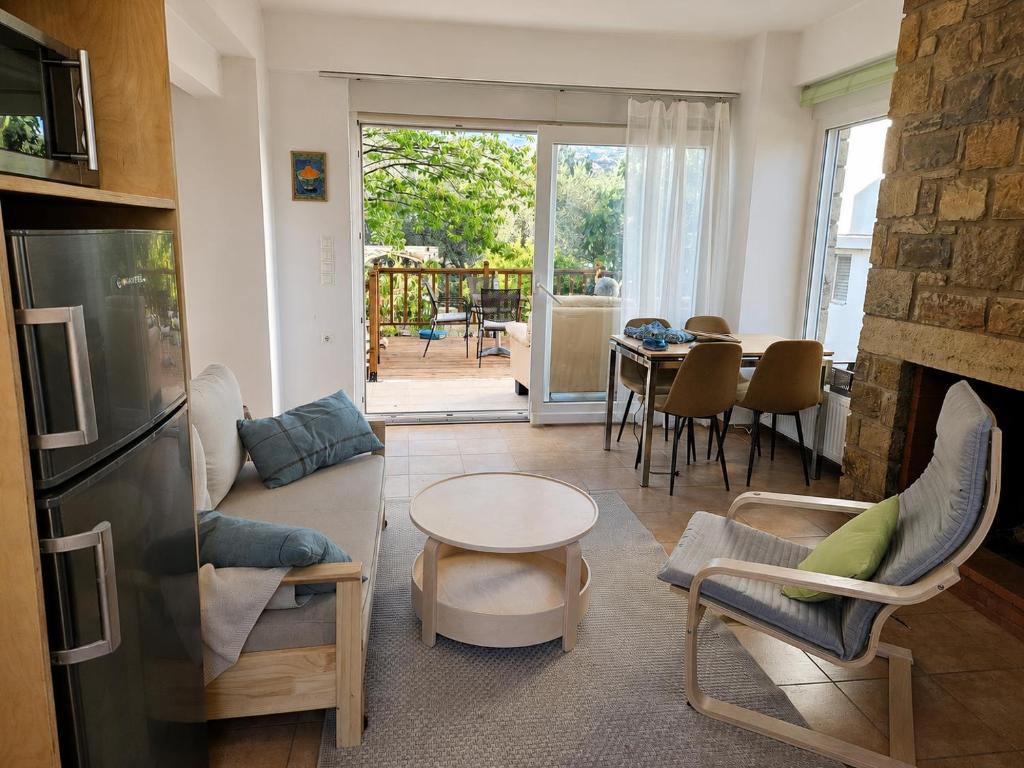 a living room with a couch and a table at Myrtos Hidden Garden Villa in Ierapetra