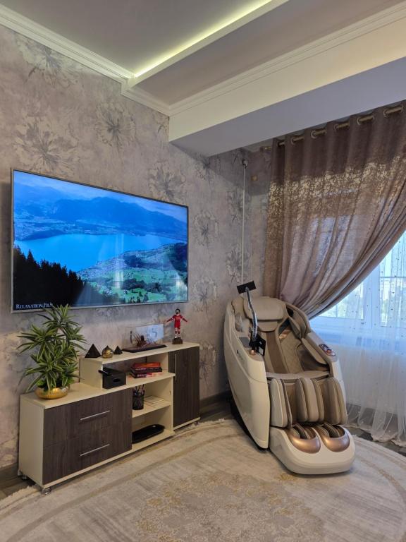 a living room with a large flat screen tv at Apartment with FREE Massage chair Fergana in Fergana