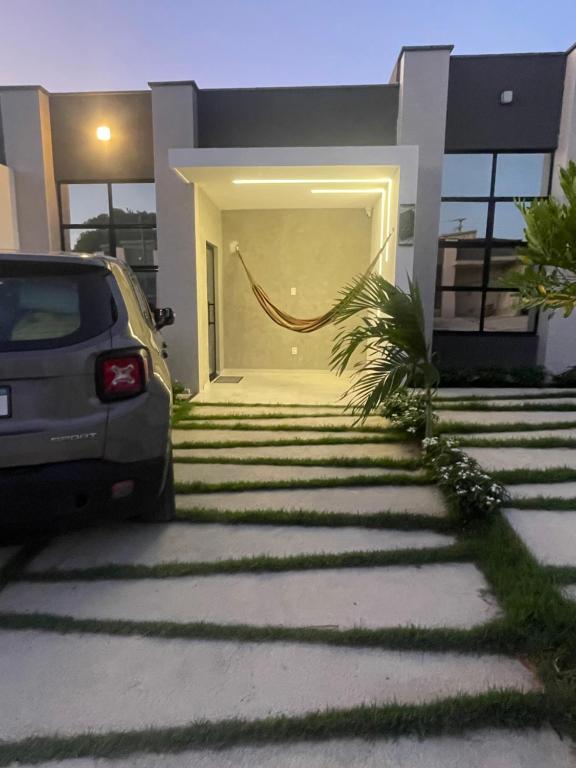 a car parked in front of a house at Casa Aquiraz in Aquiraz