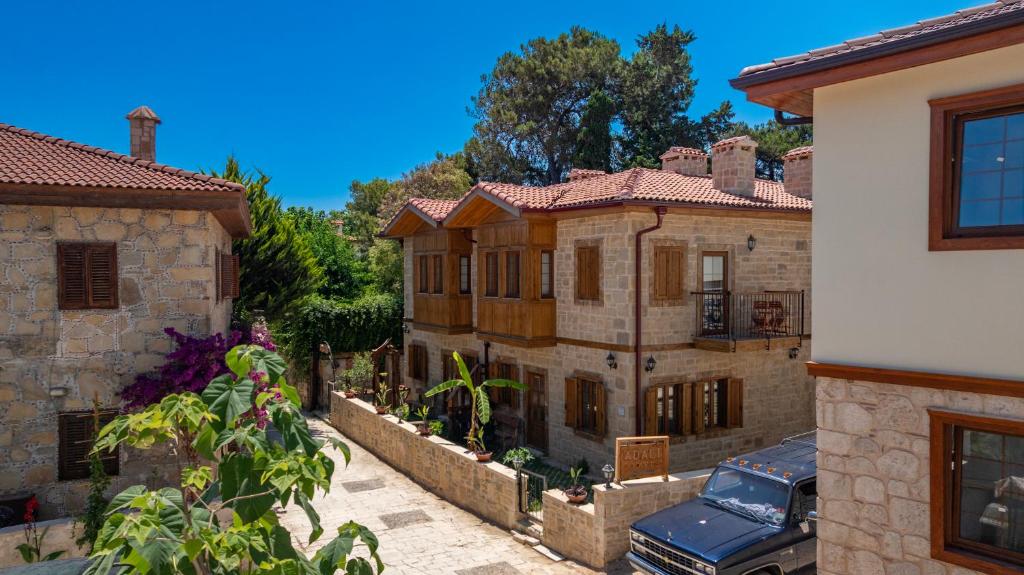 a house with a car parked in front of it at Adali Aparts in Side