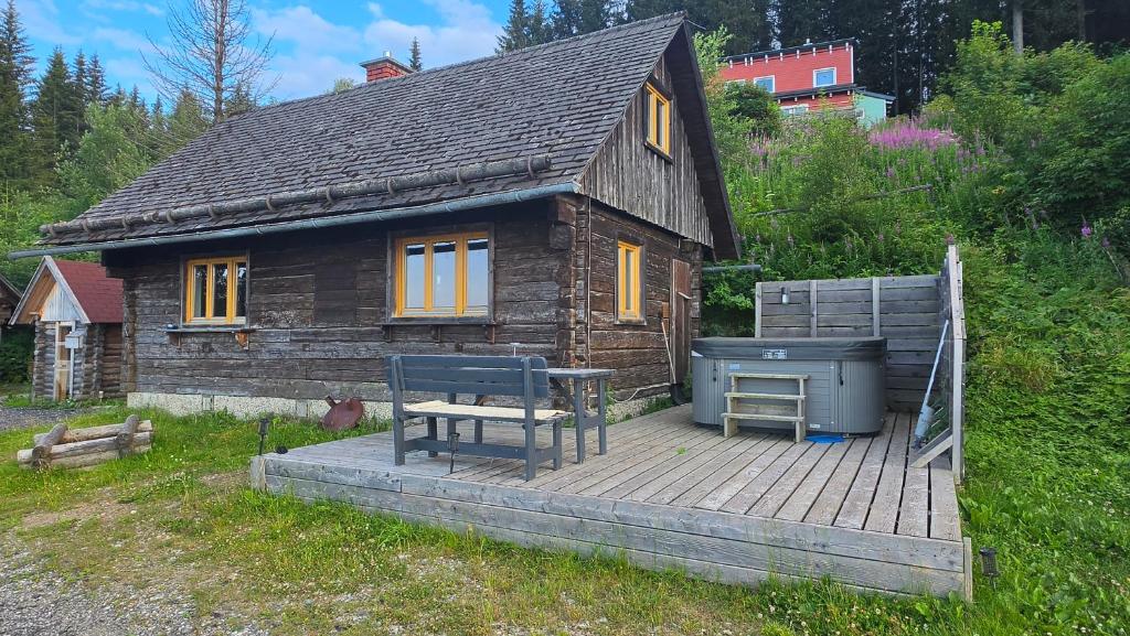 a small house with a grill on a wooden deck at miki Hütten in Pack