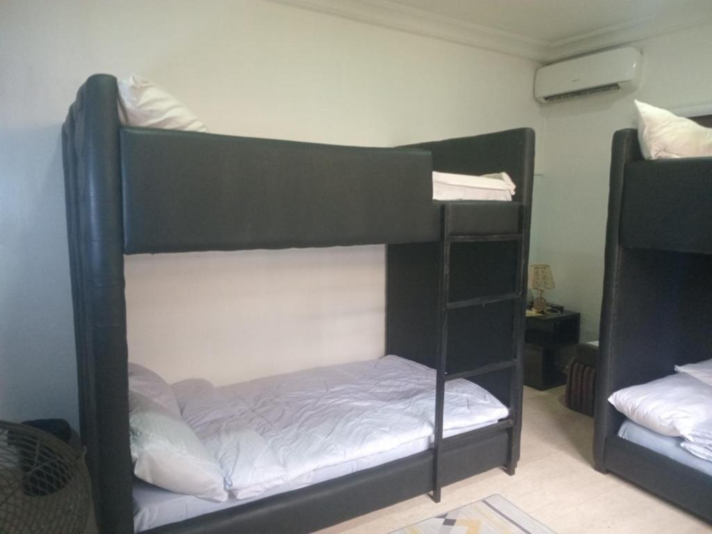 a couple of bunk beds in a room at The Close in Asaba