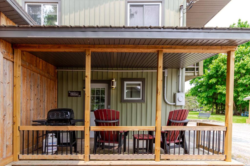 a screened in porch with chairs and a grill at Westlake Cottage - Hillier Lodge in Wellington