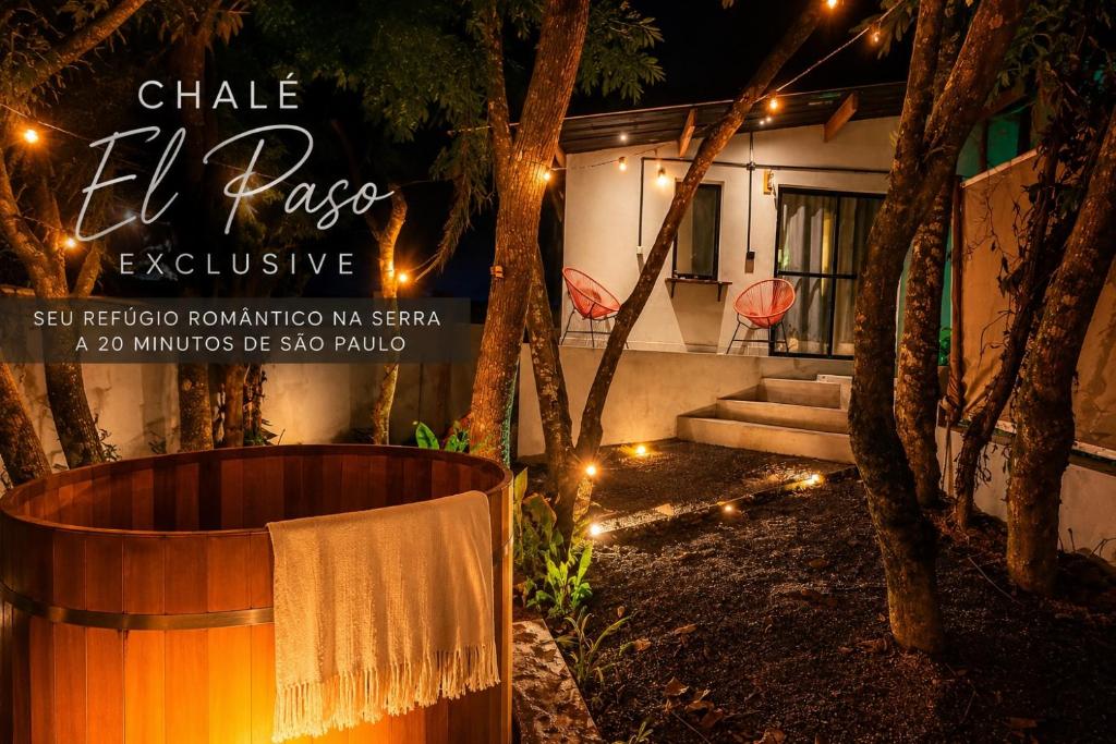 a sign for a house with lights on it at Chalé Exclusive El Paso in Mairiporã