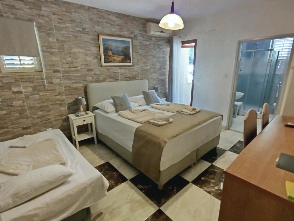 a bedroom with a bed and a brick wall at Bed and breakfast Porto del Mar in Medulin