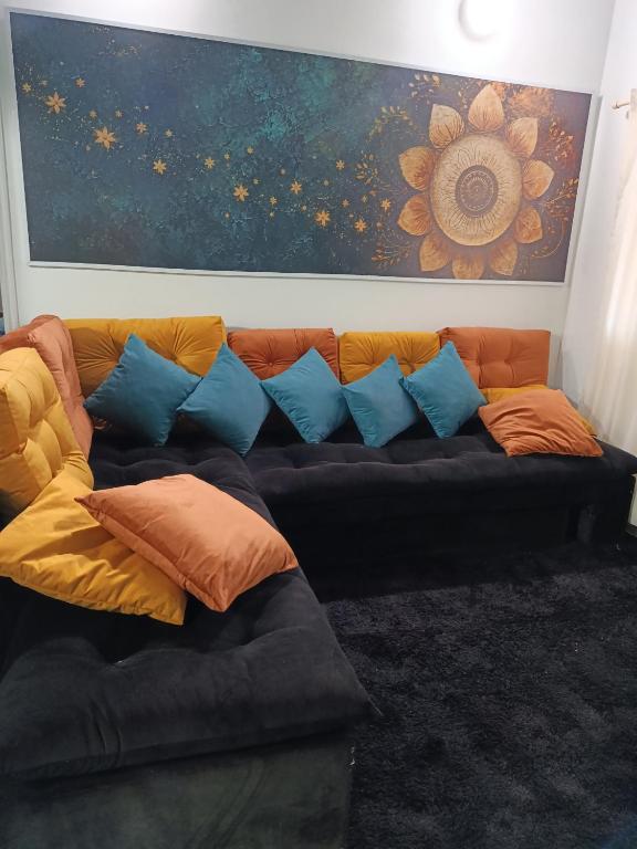 a couch with colorful pillows in a living room at Turquesa in Hernandarias