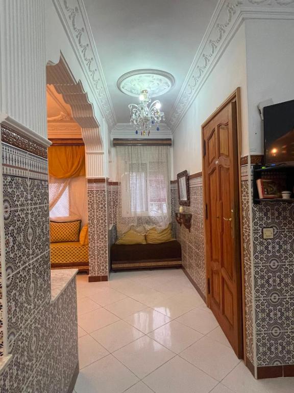 a room with a hallway with a door and a couch at Casa Amina in Martil