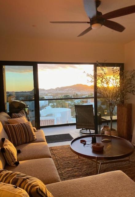 a living room with a couch and a table at Sunset view Penthouse 302 in Cabo San Lucas