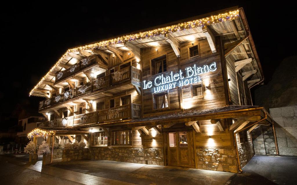 a building with a sign on the side of it at Le Chalet Blanc in Megève