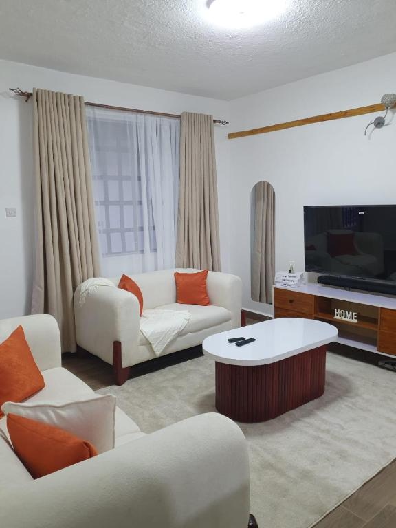 a living room with a couch and a coffee table at stayscape homes nanyuki in Nanyuki