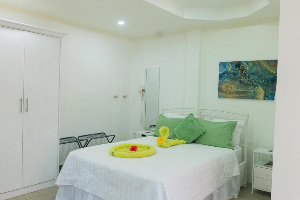 a bedroom with a bed with a toy on it at Agape Suites-Room 2-Ground Floor in Soufrière