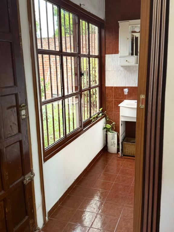 a room with a door and a window and a fireplace at Casa familiar in Corrientes