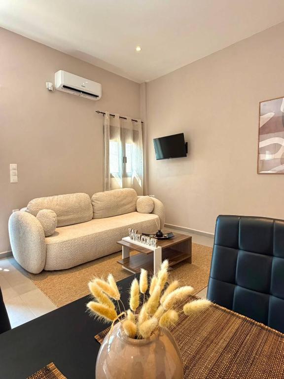 a living room with a couch and a table at STV Royal Apartments 3 in Areopoli