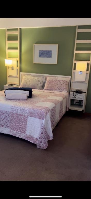 a bedroom with two beds and a ladder at Flat em Alphaville Hotel Comfort in Barueri