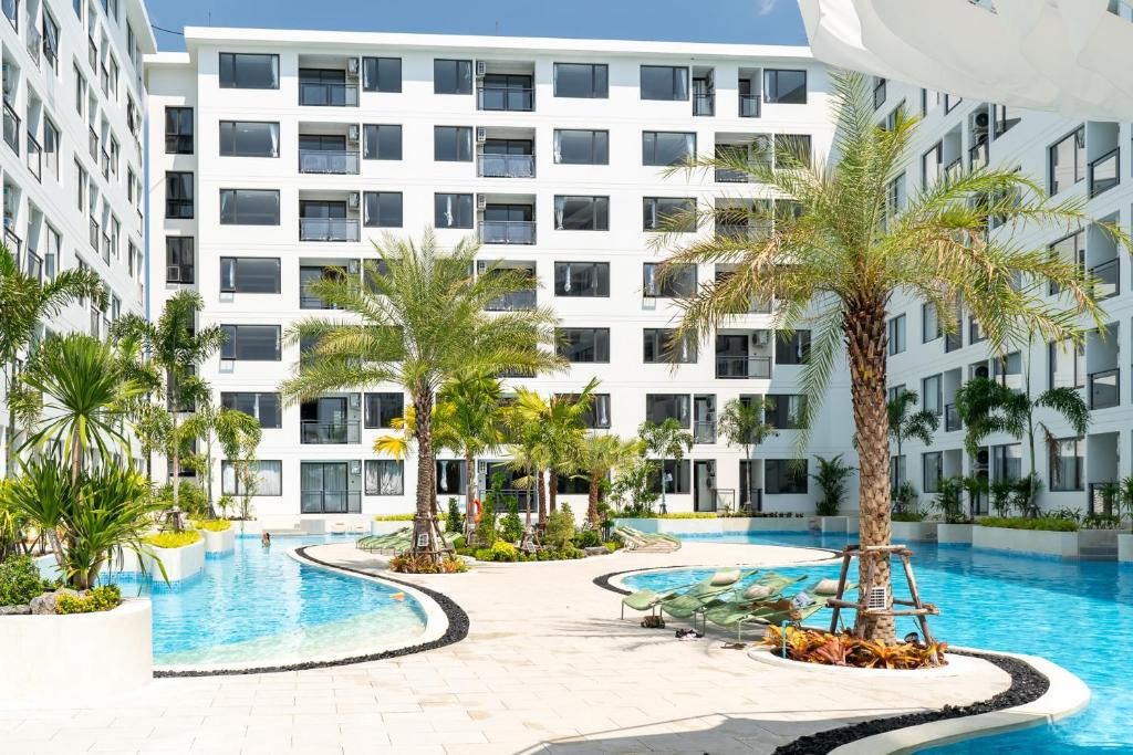 an image of a building with a swimming pool and palm trees at New Capri Condo in Bang Tao by Lofty in Ban Thalat Choeng Thale